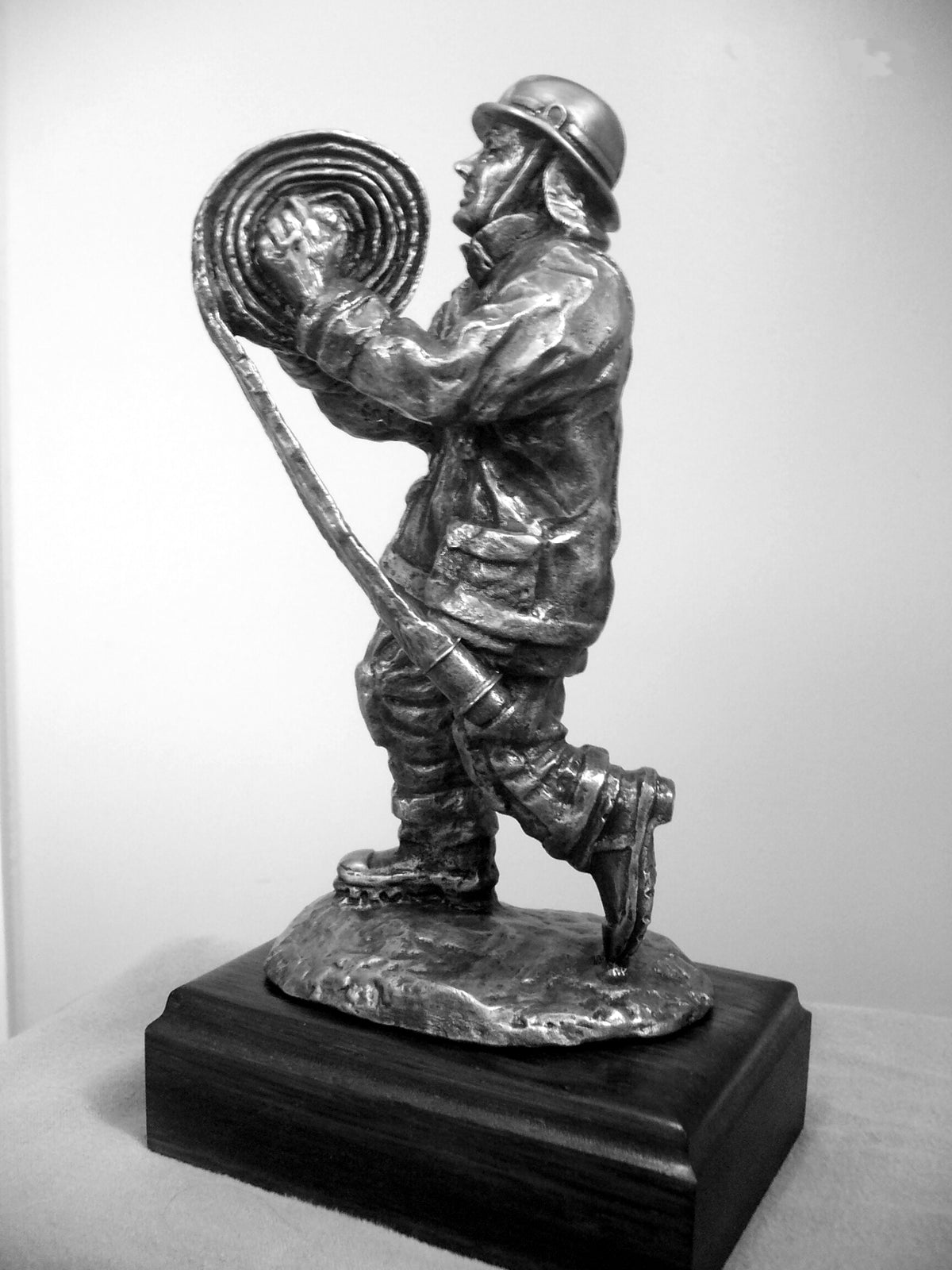 FIREFIGHTER RUNNING COILED HOSE